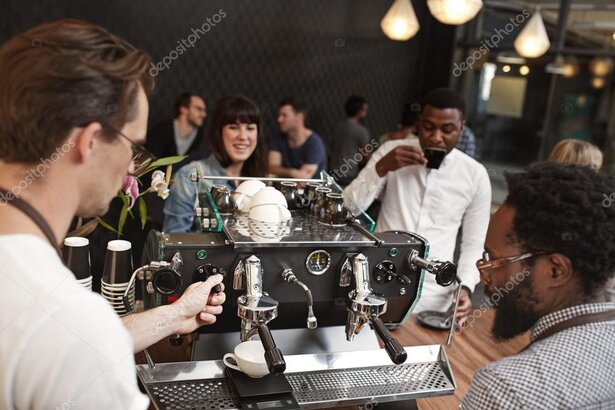 Technician training baristas on espresso machine care
