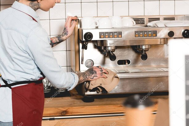 Barista cleaning a commercial espresso machine
