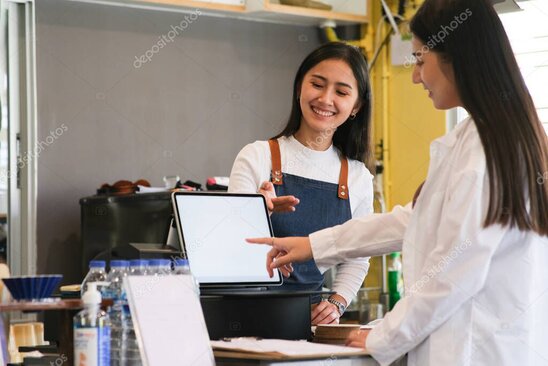 Café owner discussing coffee machine options at the bar