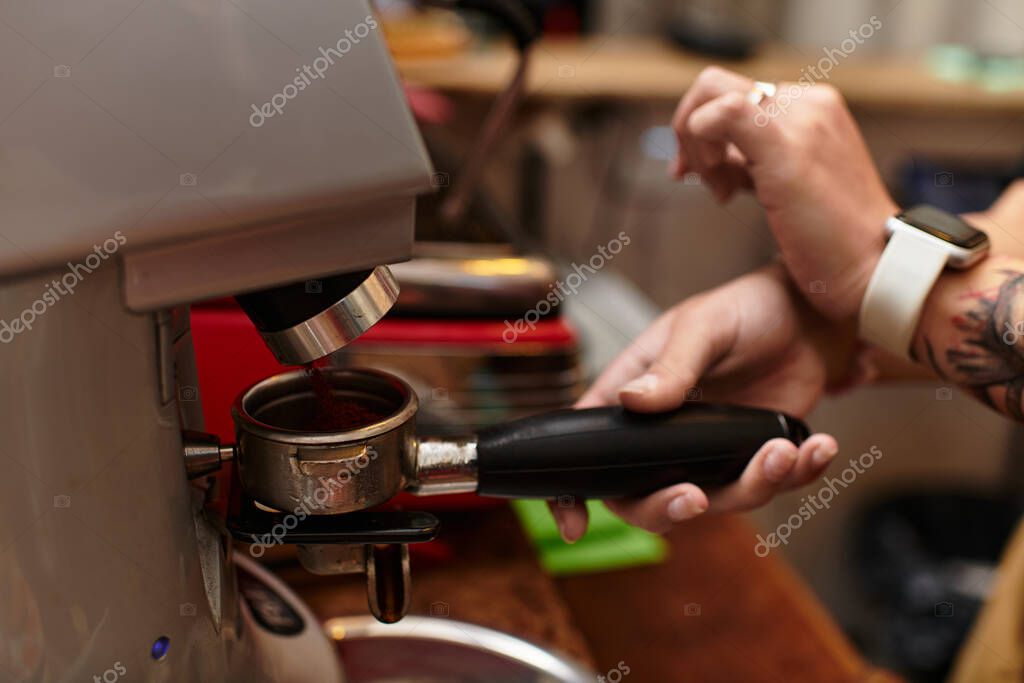 Barista working on a busy espresso machine bar
